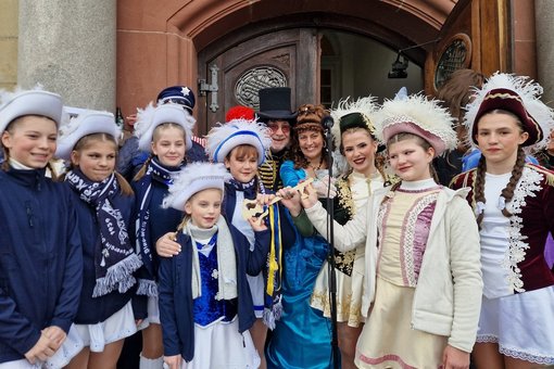 Bürgermeister und Regionalverbandspräsidentin mit Karnevalisten vorm Rathaus